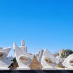 Stone bas relief sculptures stands representing the old Phoenician time with a real stone fossil